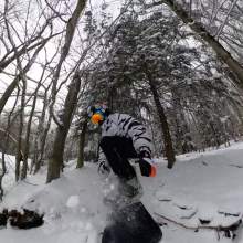 Kissing Bridge Snowboarder in woods