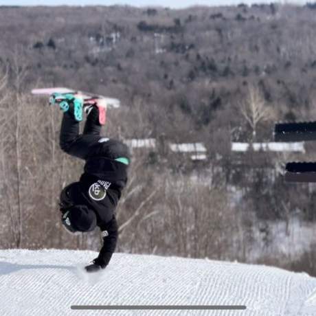 Snowboarder upside down in terrain park